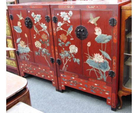 A pair of 20th century Chinese red lacquer and polychrome painted two door low cupboards, on block feet, eeach 87cm wide x 12