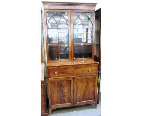 A George III mahogany secretaire bookcase, the pair of astragal glazed doors over fitted drawer and pair of cupboards, on bra