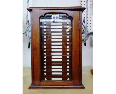 A Victorian mahogany optician's cabinet by Negretti and Zambra, with hinged glazed door enclosing nineteen drawers, 37.5cm hi