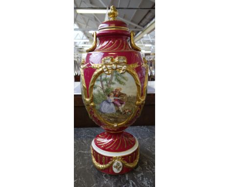 A Sevres style lidded vase, early 20th century, the cover with gilt pineapple finial, decorated with four oval panels each de