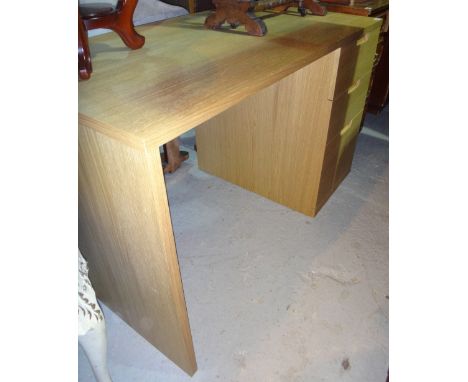 A 20th century light oak desk.