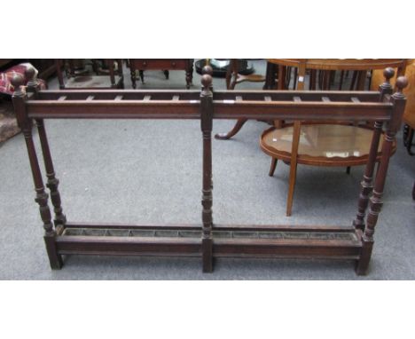 A 19th century oak narrow twelve division umbrella/stick stand on turned supports, 122cm wide.