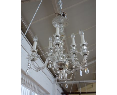A six branch glass chandelier, 20th century, the moulded glass foliate stem issuing six swan neck arms united by "y" glass be
