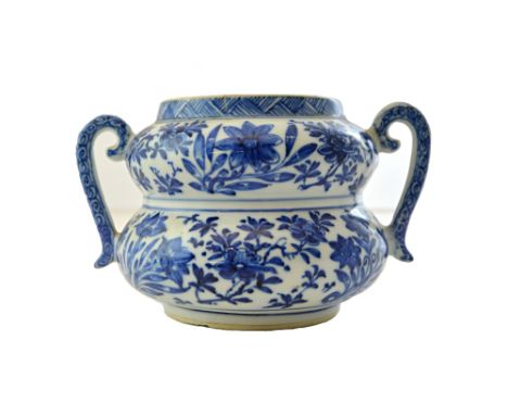 A rare Chinese porcelain blue and white double-gourd jar, Kangxi, painted with sprays of lotus, peony and orchid, set with tw