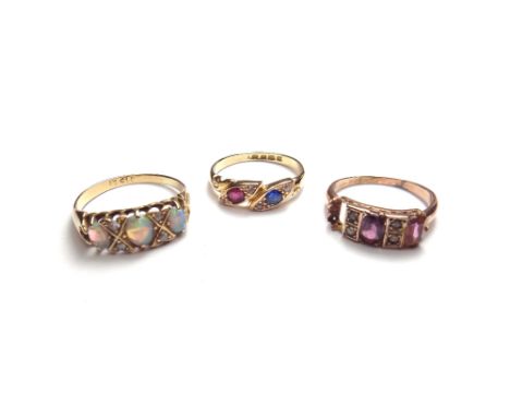 An 18ct gold, ruby, sapphire and diamond set ring, in a twistover design, London possibly 1898, an 18ct gold, opal and diamon