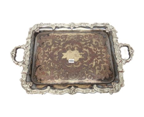 A plated on copper shaped rectangular twin handled large tray, first half of the 19th century, the centre with floral, scroll