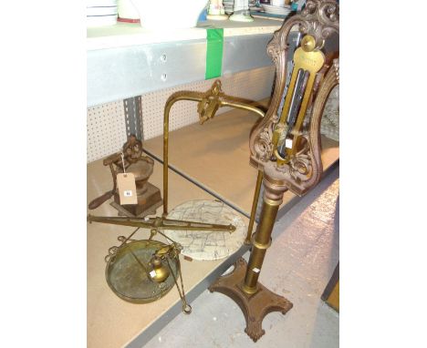 A large iron and brass balance scale and an 'ELMA' coffee grinder.