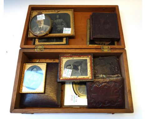 A quantity of Victorian black and white miniature photographs, each depicting family members, mostly housed in an embossed le