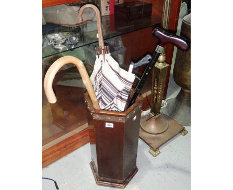 A 20th century mahogany stick stand and a quantity of sticks.