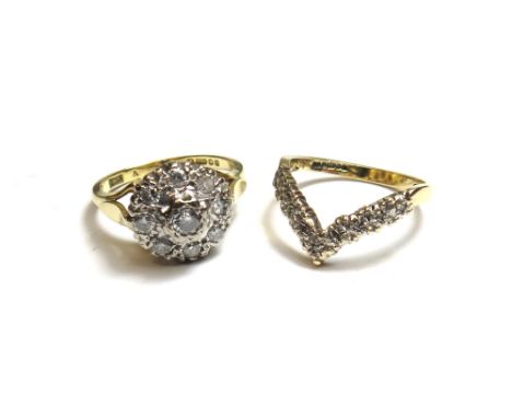 An 18ct gold and diamond set nine stone cluster ring, mounted with the principal circular cut diamond at the centre, in a sur