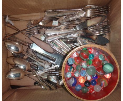 A quantity of silver plated flatware and a circular box containing marbles.