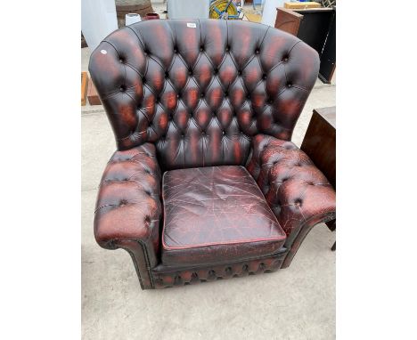 AN OX-BLOOD BUTTON BACK EASY CHAIR 
