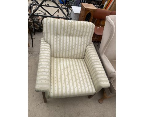 A RETRO TEAK FRAMED FIRESIDE CHAIR WITH BUTTON-BACK 
