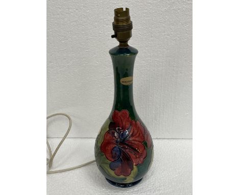 A MOORCROFT HIBISCUS ON GREEN LAMP 