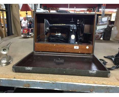 A CASED VINTAGE SINGER SEWING MACHINE 