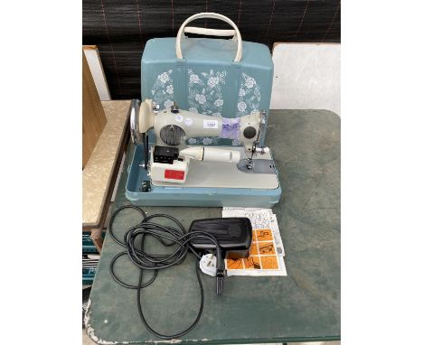 A RETRO JONES SEWING MACHINE WITH WORK LIGHT, FOOT PEDAL AND CARRY CASE 
