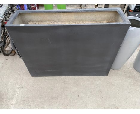 A LARGE RECTANGULAR BLACK FIBRE GLASS PLANTER (L:120CM H:90CM) 