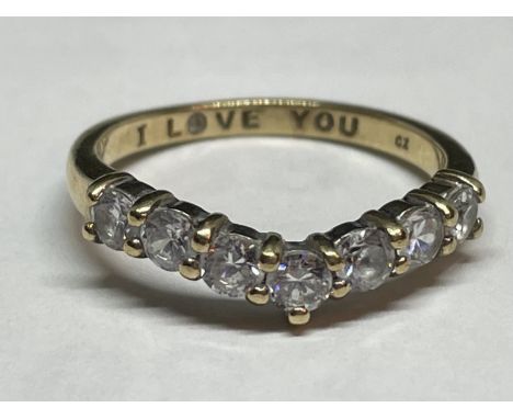 A 9 CARAT GOLD WISHBONE RING WITH SEVEN CLEAR STONES SIZE M/N AND ENGRAVED WITH I LOVE YOU ON THE INSIDE 