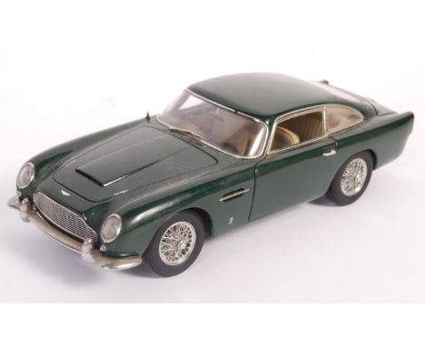 An original Autoart 1/18 scale diecast model Aston Martin DB5 in British Racing Green. Model appears in good displayed condit