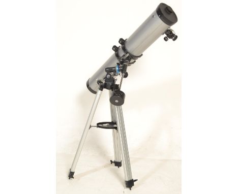 A 20th century scientific Celestron PowerSeeker 114 coated optics telescope marked D=114mm F=900mm raised on a tripod base. T