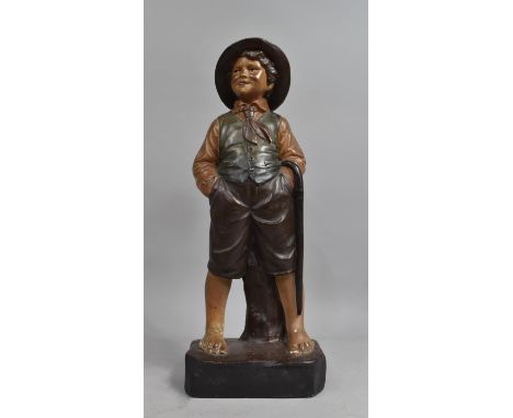 A Continental Cold Painted Plaster Study of a Boy with Hands In Pockets and Carrying Walking Stick, 44cms High 