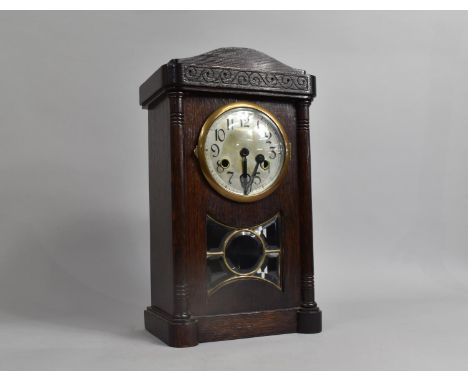 An Edwardian Oak Cased Mantel Clock with Glazed Pendulum Glass, Movement Detached and in Need of Attention, 38cms High 