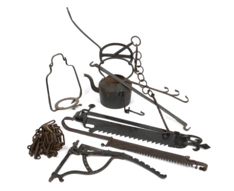 An iron range swing bracket and other fire cooking implementsTo include a large iron kettle and further brackets chains etc, 