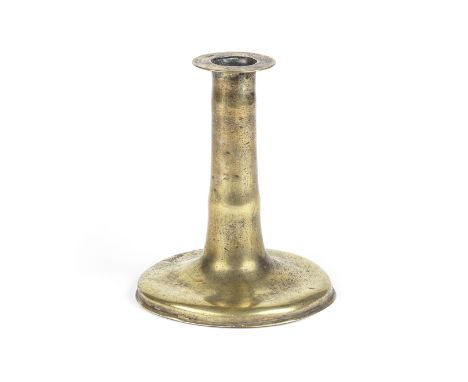 A brass trumpet candlestickCirca 1650-1670The tapering shaft with a single swelling, on moulded circular base, 15cm highFor f