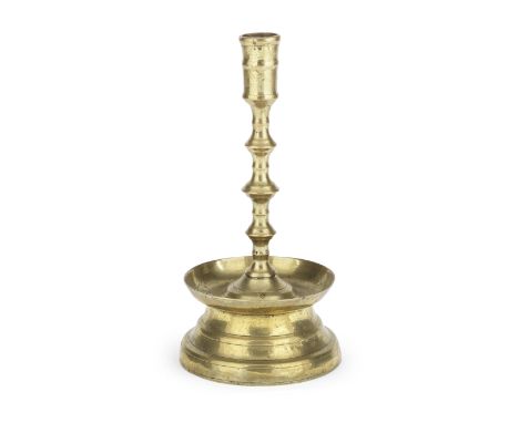 A copper alloy candlestickFlemish/Netherlandish, circa 1500The shaft with three knops, above a circular two stage spreading b