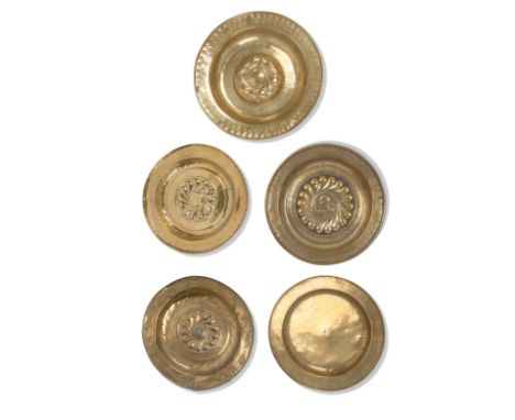 A group of five brass alms dishes16th and 17th centuryThe first four examples of Nuremburg type, of circular form with foliat