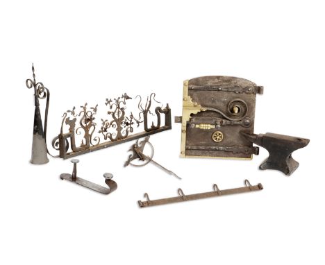 A wrought iron door-top frieze and other piecesThe frieze with scroll and other patterns, 63cm wide; an anvil; a finial; thre