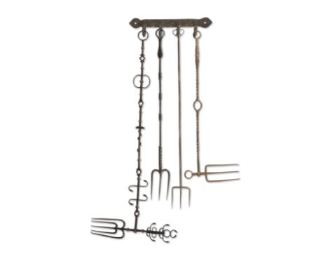 An elaborate 18th century toasting forkWith a rotating horizontal fork and further motifs to the column, 66cm long; with thre