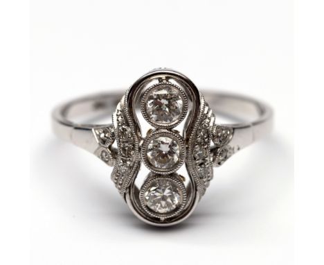14 kt. Witgouden prinsessen ring in Art Deco stijl. Het middendeel bezet met drie met oud briljant geslepen diamanten, de sch