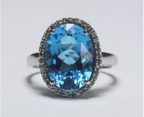 A 9ct white gold Topaz and diamond ladies dress ring, oval faceted Topaz, 15x11mm, surrounded by 35x small diamonds 4.2g 
