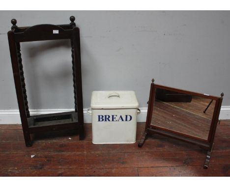 A stained oak umbrella stand with bobbin turned supports and metal drip tray, together with a 19th C mahogany toilet mirror a