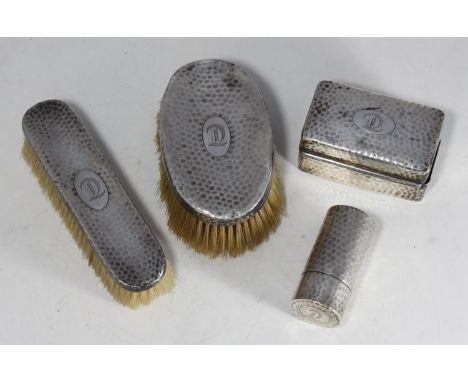 A four-piece silver dressing table set by Finnigans Ltd, comprising two brushes, a small box and a cylindrical pot, all with 