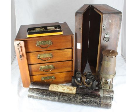 An Edwardian walnut table-top Wellington 'style' lockable four-drawer chest together with a a Davy lamp, binoculars, wooden b