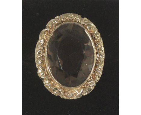 A 9ct gold dress ring set with a large oval faceted smoky-quartz, 13.3g gross, stone 20x14mm 