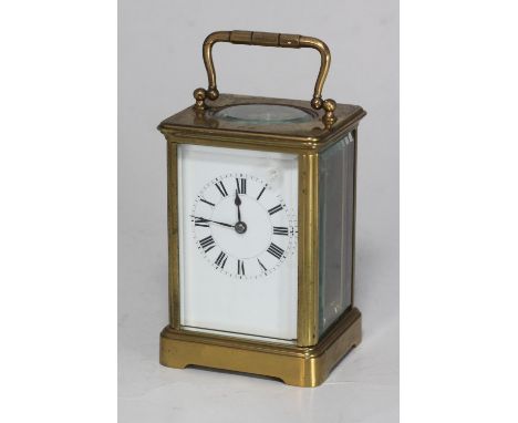 An early 20th century brass carriage timepiece with French movement, and key, enamel dial, Roman numerals 