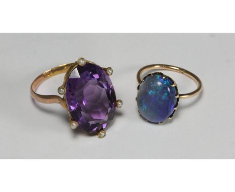 An antique 9ct gold and seed pearl ring centrally set with a large oval faceted amethyst, together with a 9ct gold and opal r