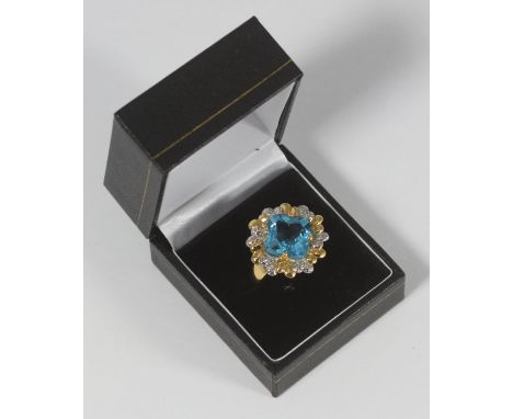 A 14k bi-colour gold dress ring set with a faceted quartrefoil-cut blue topaz, 6.2g 