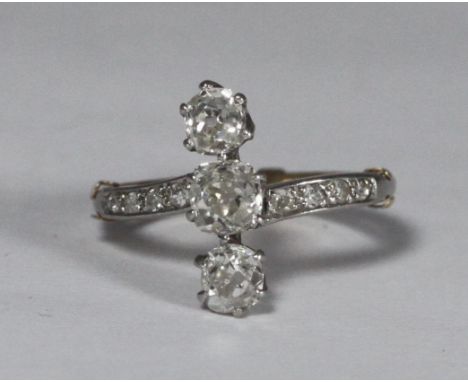 A white-gold and diamond ring 'made up,' from a three-stone Old Cushion Cut diamond engagement ring, (estimate 1 carat total)