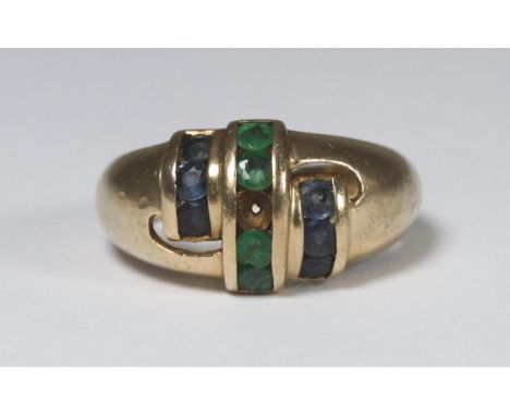 A 9ct gold gent's ring set with a central row of emerald coloured stones (one missing), flanked either side by a row of sapph