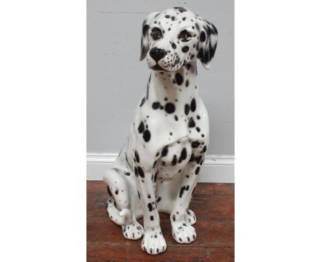 A life size ceramic model of a seated Dalmatian dog, 78cm tall 