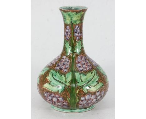 A Della Robbia pottery vase of onion form, incised and painted decoration of stylised fruiting grape vine, incised mark to ba