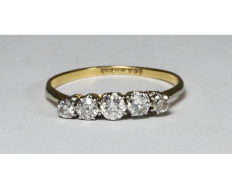 An 18ct gold and platinum five stone diamond ring, estimated total diamond weight 0.50cts, gross weight approximately 1.9g 