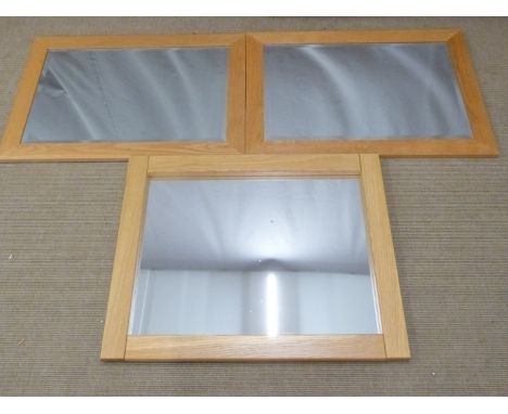 Three light oak mirrors, two with bevelled glass, largest 70 x 88cm