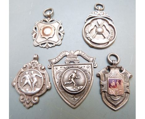 Four silver football award watch fobs together with a miniature shield, Aston Junior League, believed to be mostly Bristol Ro