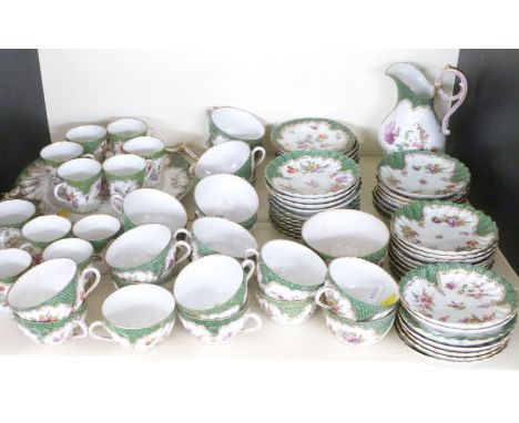 A quantity of Dresden porcelain tea and coffee ware with wrythen moulded, floral decoration and green scale border, approxima