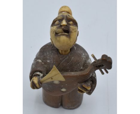 Chinese sandalwood and ivory netsuke depicting a man playing a lute with moving tongue, 7cm&nbsp;